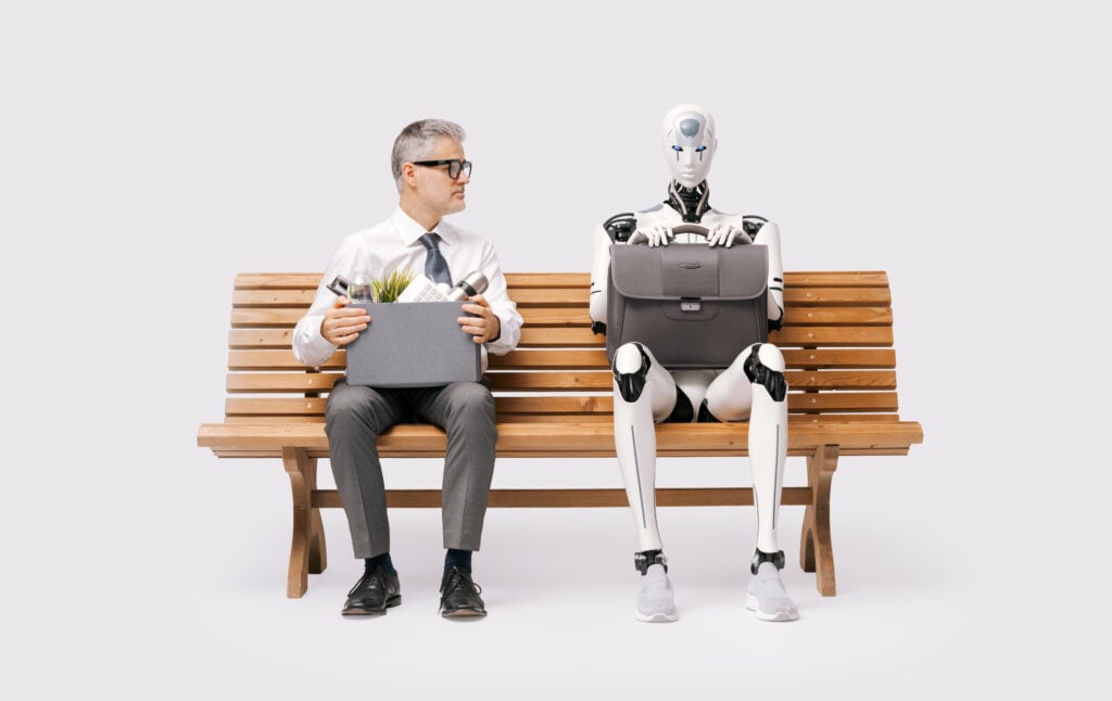 man and robot sitting bench waiting for bus to go to their jobs