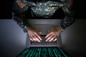 secret wars American soldier in military uniform preventing cyber attack in military intelligence center. An US officer intercepting messages to stop terrorism. Modern warfare system surveillance concept.